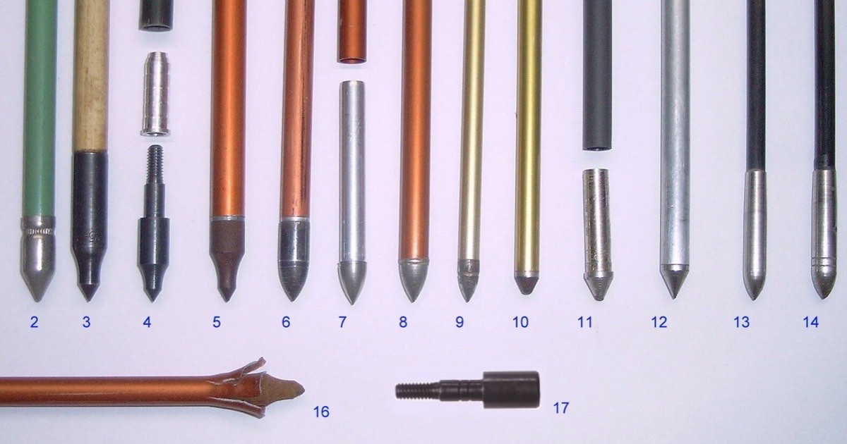 A row of arrow points of different shapes and weights laid out side by side, with an insert and a broadhead