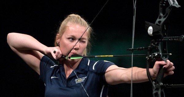 Compound archer at full draw with a release aid held at the jaw and the string touching the face