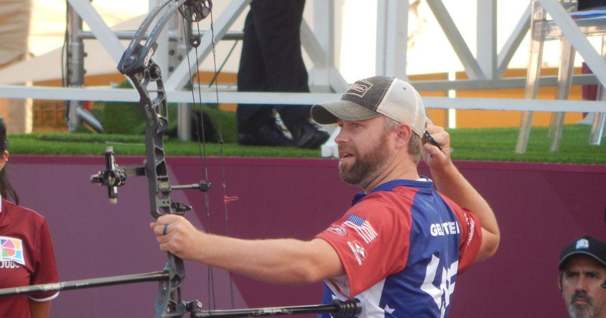 A compound archer at full draw with sight and stabiliser, arrows in a hip quiver