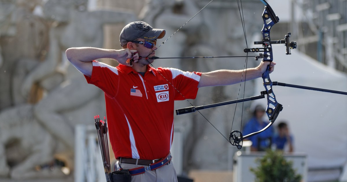 Compound archer at full draw using a release aid at an outdoor World Cup competition