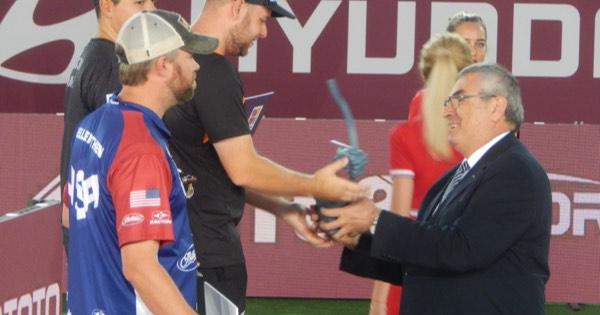 Award presentation to a compound archer in a USA jersey at the 2019 Archery World Cup Final in Moscow