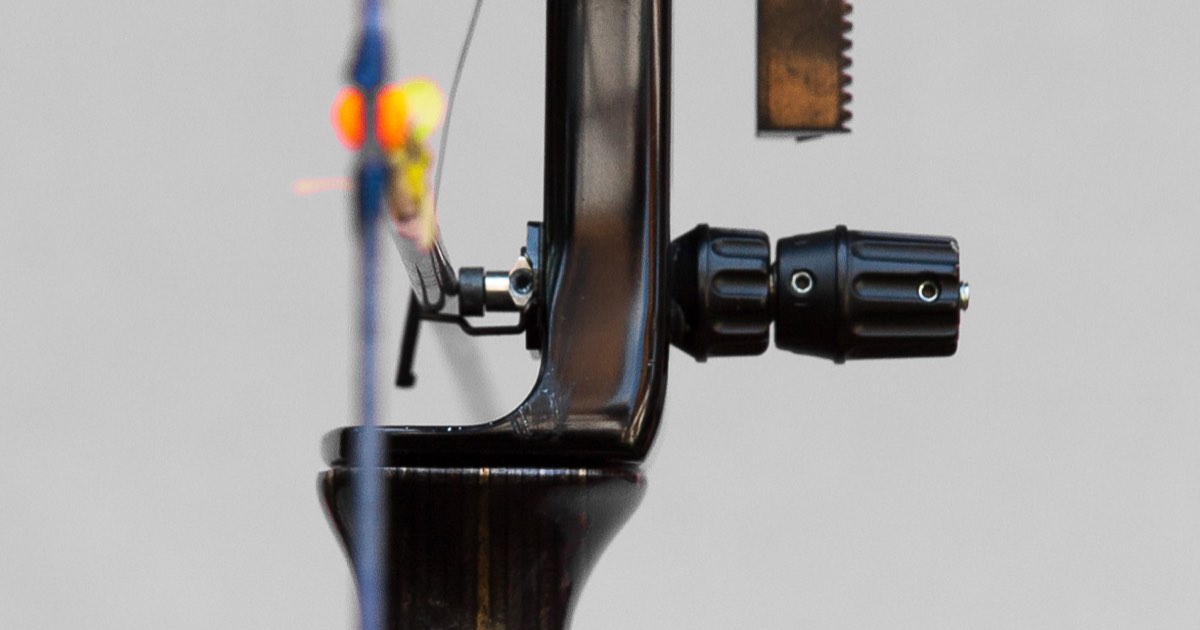 Close-up of a pressure (plunger) button and arrow rest on a target recurve riser