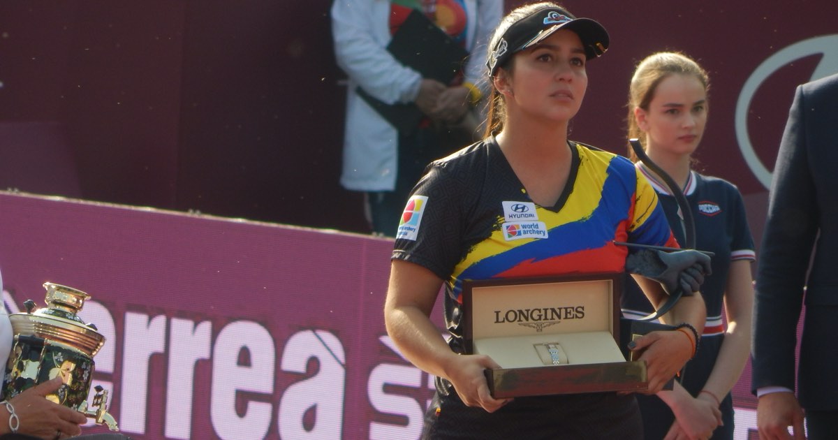 Sara López of Colombia holding a presentation watch box at the 2019 Archery World Cup Final award ceremony